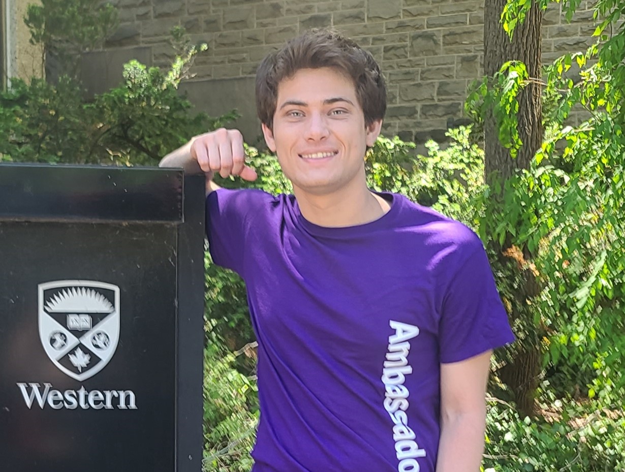 Photograph of Kristian standing on campus.